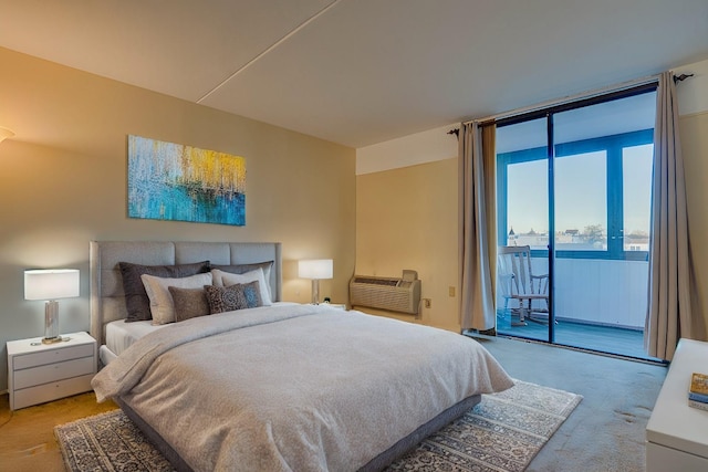 bedroom featuring light colored carpet, access to outside, a wall unit AC, and expansive windows