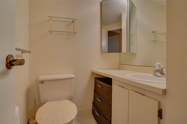 bathroom with vanity, toilet, and tile patterned flooring