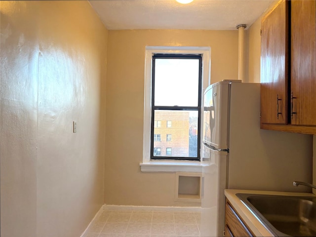 kitchen featuring a textured ceiling and sink