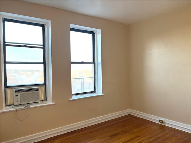 unfurnished room with hardwood / wood-style floors and cooling unit