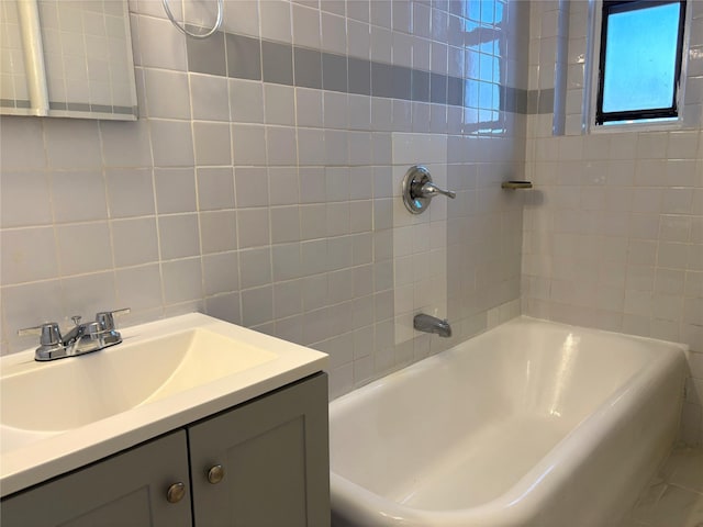 bathroom featuring vanity and tile walls