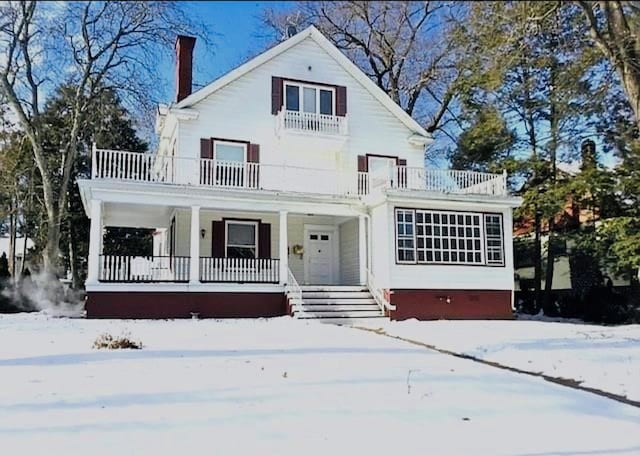 view of front of house featuring a porch and a balcony