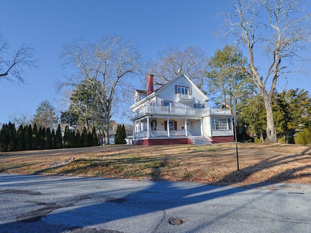 victorian home with a balcony and covered porch