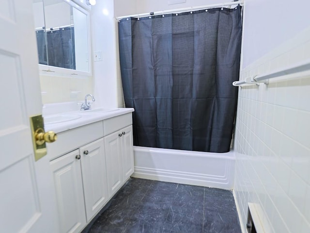 bathroom with tile patterned floors, shower / tub combo with curtain, vanity, and tile walls