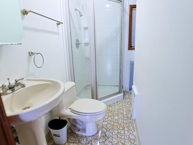 bathroom featuring tile patterned floors, toilet, and walk in shower