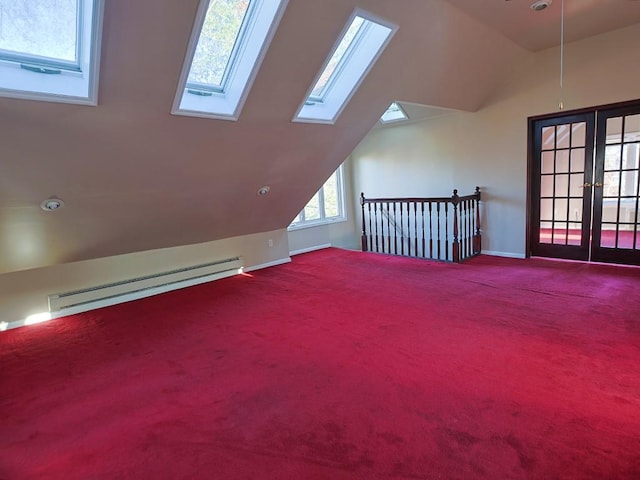 bonus room featuring carpet flooring, a healthy amount of sunlight, lofted ceiling with skylight, and a baseboard radiator