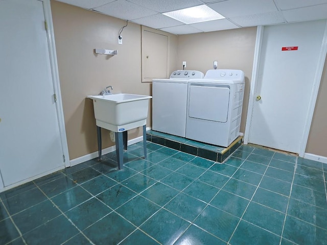 washroom featuring separate washer and dryer and dark tile patterned flooring