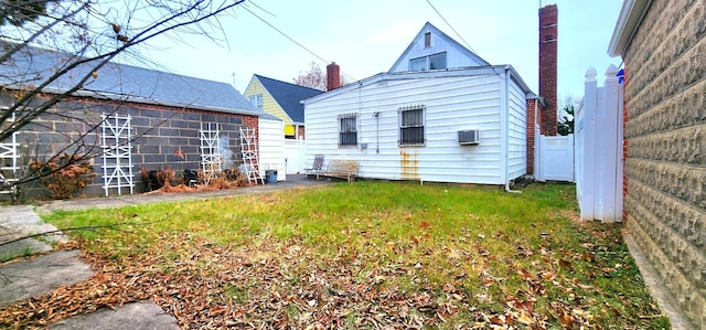 rear view of house featuring an AC wall unit