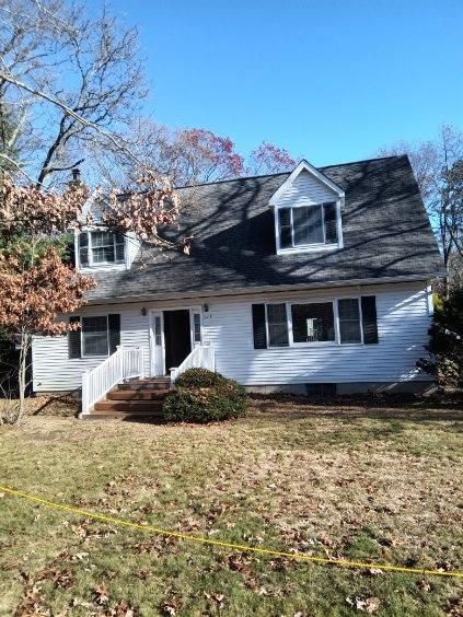 new england style home with a front yard