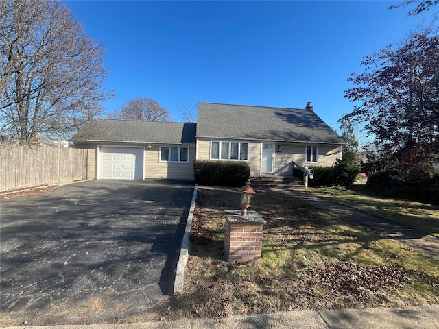 ranch-style home with a garage and a front lawn