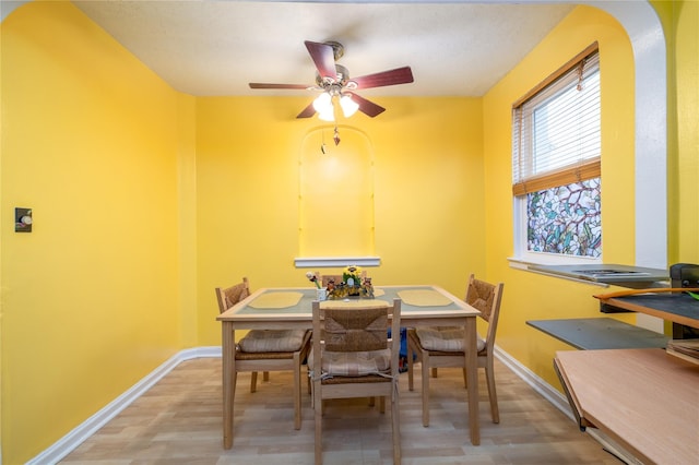 dining space featuring ceiling fan and light hardwood / wood-style floors