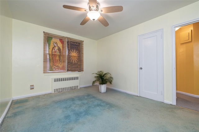 empty room with ceiling fan, radiator heating unit, and light colored carpet