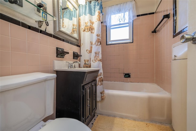 full bathroom featuring shower / bath combination with curtain, toilet, tile walls, and vanity