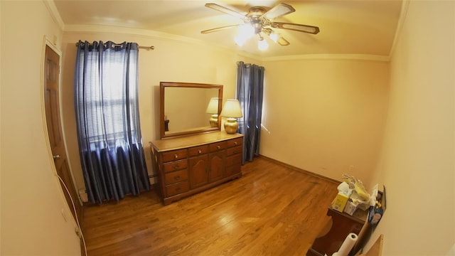 interior space with ceiling fan, ornamental molding, lofted ceiling, and light hardwood / wood-style floors