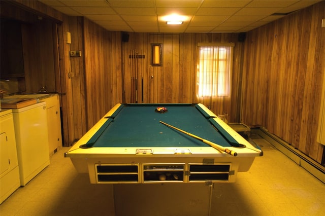 rec room featuring a paneled ceiling, independent washer and dryer, and wood walls