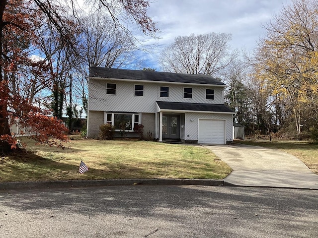 front of property featuring a front yard and a garage