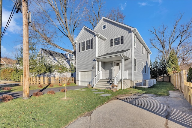 front of property with a front lawn and a garage