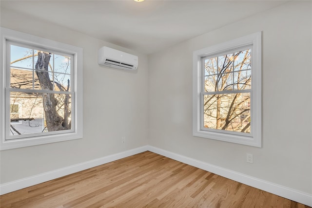 unfurnished dining area with light wood-type flooring and a wall mounted AC