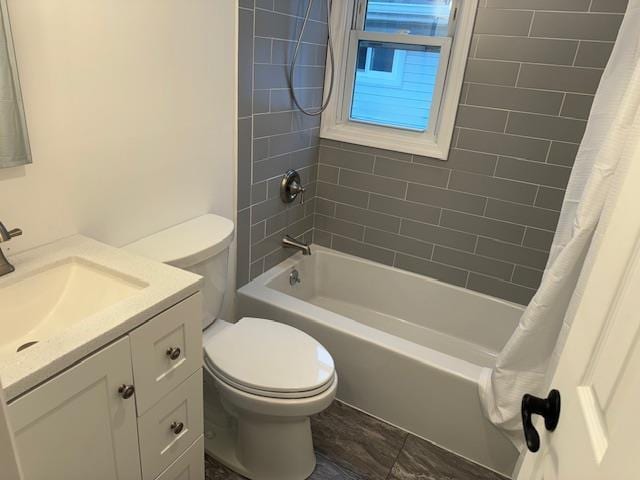 full bathroom with shower / tub combo with curtain, vanity, and toilet