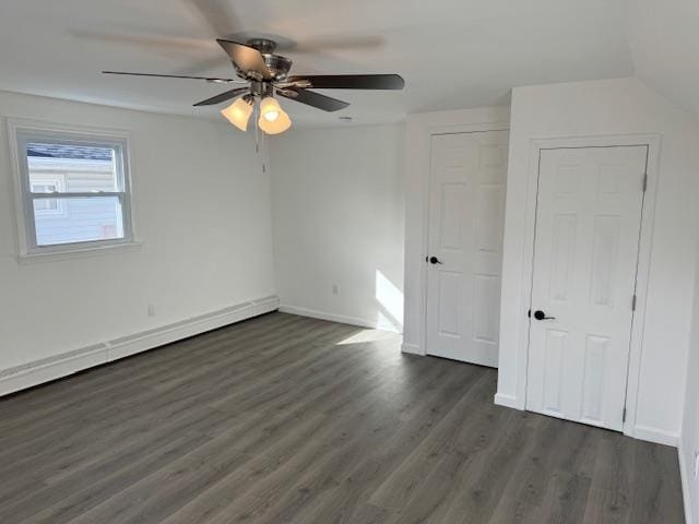 interior space featuring lofted ceiling, baseboard heating, ceiling fan, and dark wood-type flooring