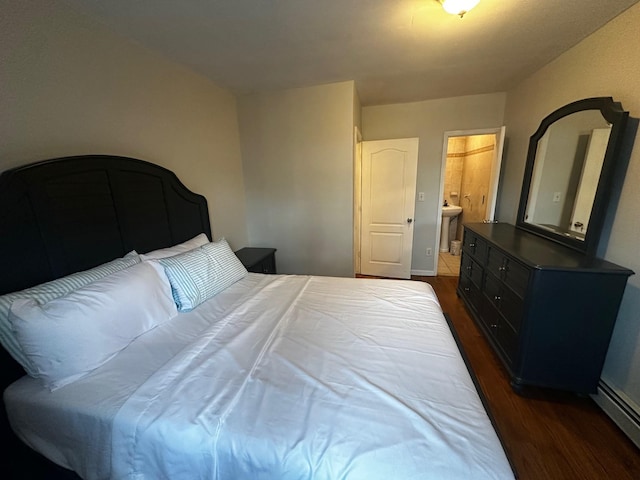 bedroom with dark hardwood / wood-style floors and ensuite bath