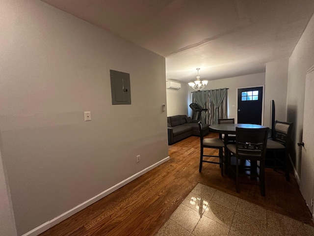 dining space featuring wood-type flooring, electric panel, an AC wall unit, and a notable chandelier