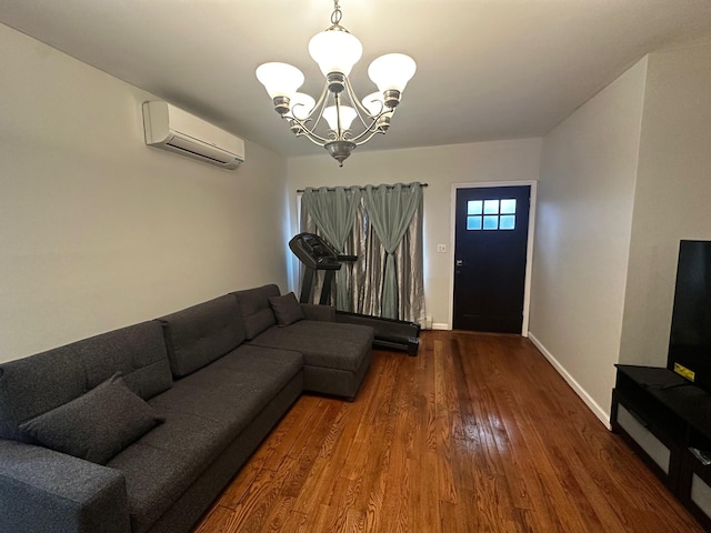 living room featuring wood-type flooring, a wall unit AC, and an inviting chandelier