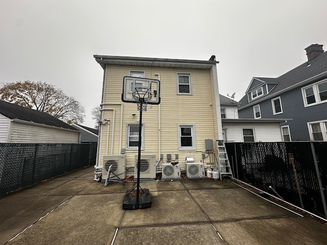 back of property with ac unit and a patio area