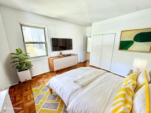 bedroom featuring parquet floors and a closet