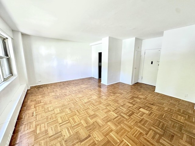 unfurnished room with light parquet floors