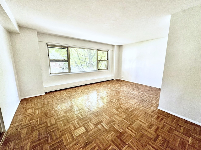 empty room featuring dark parquet flooring