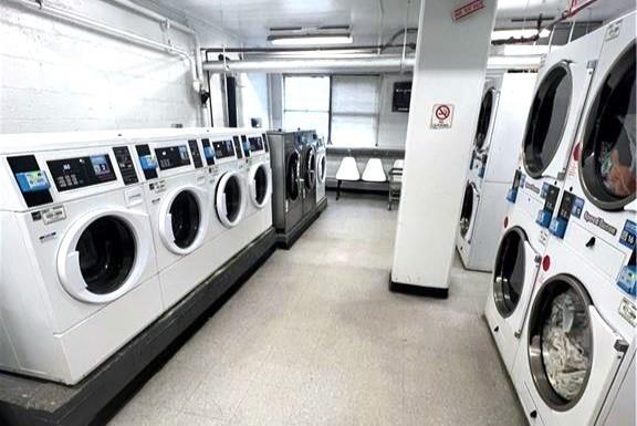 laundry room with washing machine and clothes dryer and stacked washer and dryer