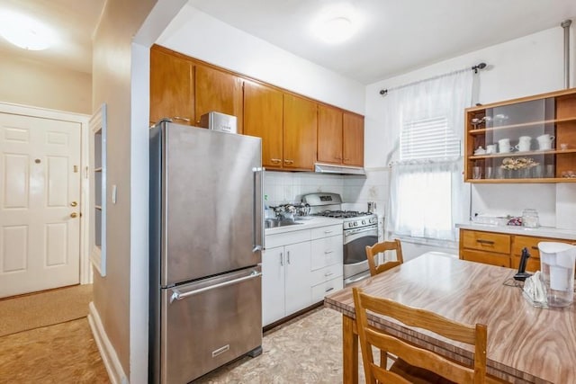 kitchen featuring stainless steel appliances and tasteful backsplash