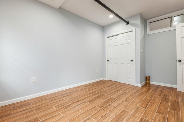 unfurnished bedroom with light wood-type flooring and a closet