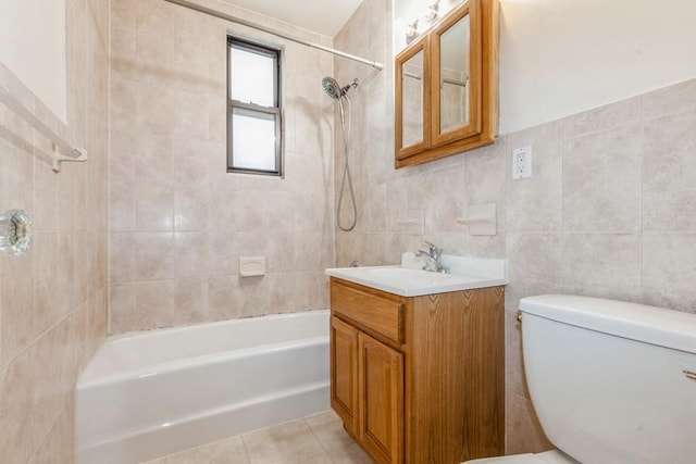 full bathroom featuring tile patterned floors, vanity, tile walls, and toilet