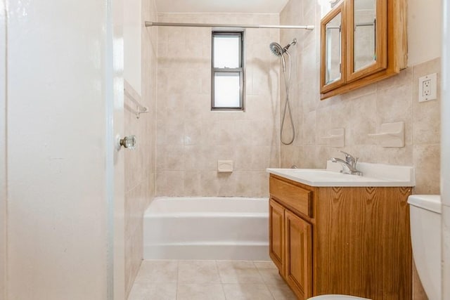 full bathroom featuring tile patterned flooring, vanity, tile walls, and toilet