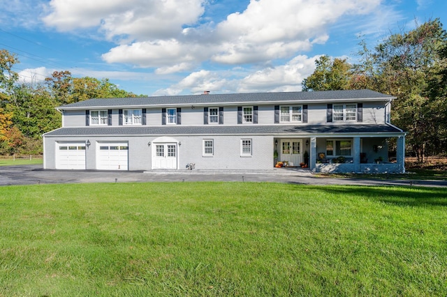 151 Burrows Ln, Blauvelt, NY 10913 - colonial house featuring a front lawn, asphalt driveway, a porch, and a garage