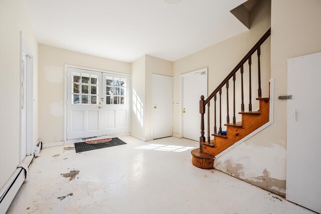151 Burrows Ln, Blauvelt, NY 10913 - entrance foyer featuring a baseboard heating unit, stairway, concrete flooring, and baseboard heating
