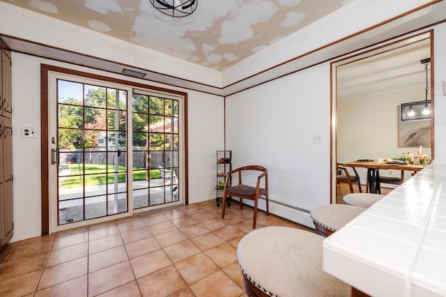 sitting room featuring light tile patterned floors, a baseboard radiator, and ornamental molding