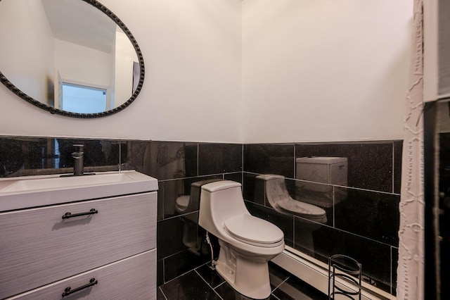 bathroom featuring tile patterned flooring, vanity, tile walls, and toilet