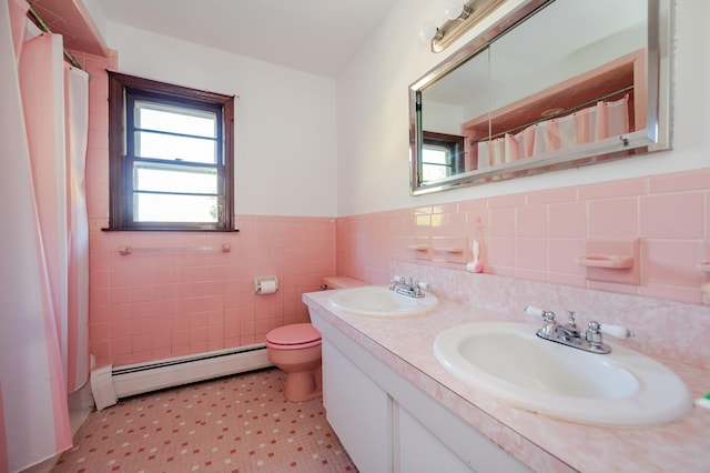 bathroom featuring vanity, a shower with curtain, toilet, baseboard heating, and tile walls