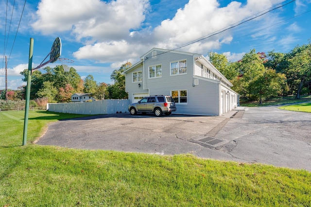 view of side of property with a garage and a yard