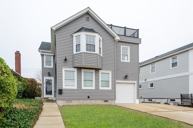 view of front of property with a balcony, a front yard, and a garage