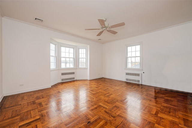 spare room with plenty of natural light, radiator, and ornamental molding