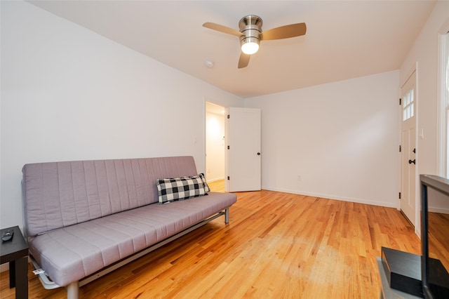 living area with light wood-type flooring and ceiling fan