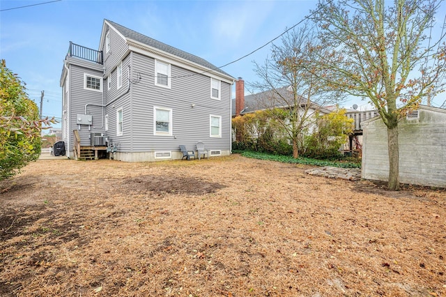 rear view of property featuring a balcony