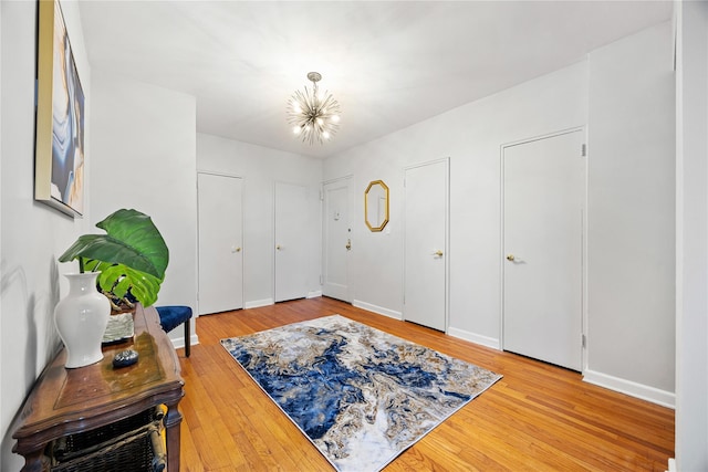 entrance foyer with wood-type flooring and an inviting chandelier