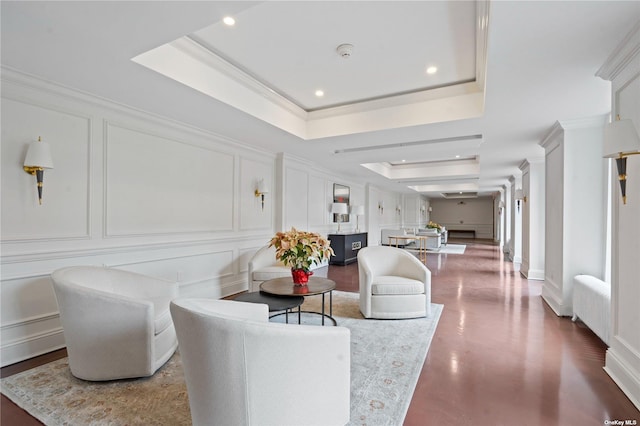 living room featuring ornamental molding and a raised ceiling