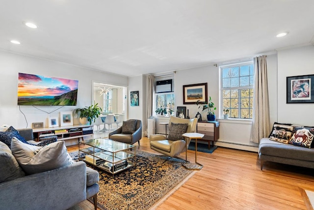 living room featuring hardwood / wood-style flooring, ornamental molding, an AC wall unit, and a baseboard heating unit