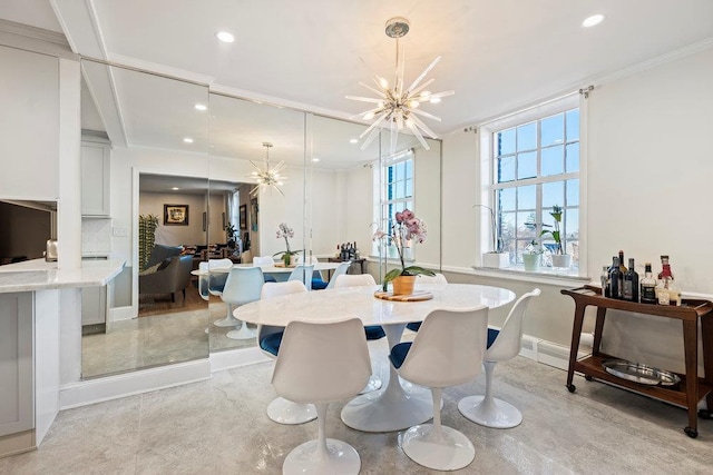 dining area featuring crown molding and a chandelier